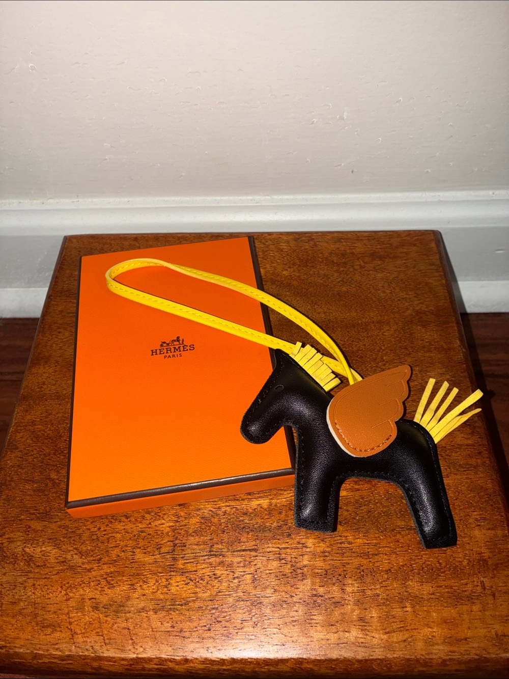 black leather pegasus bag charm featuring contrasting brown